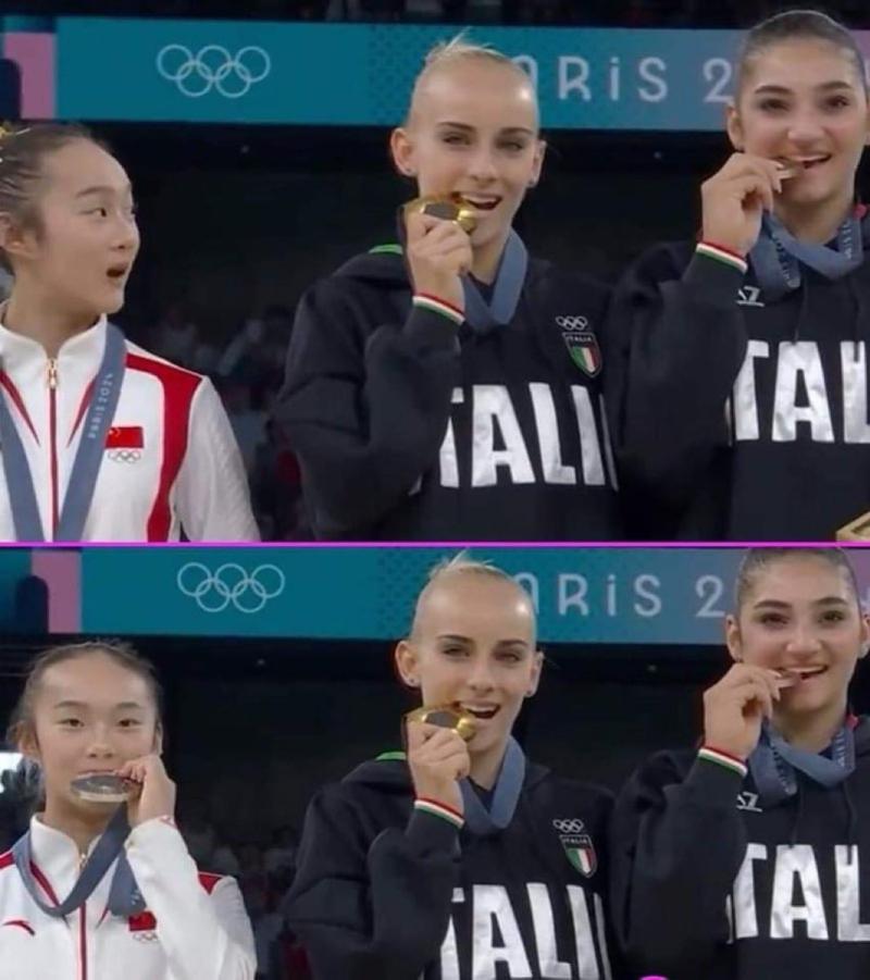 La gimnasta de China se sorprende al ver a sus rivales italianas morder la medalla.