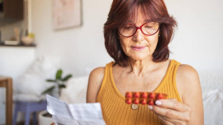 Mujer adulta tomando pastilla