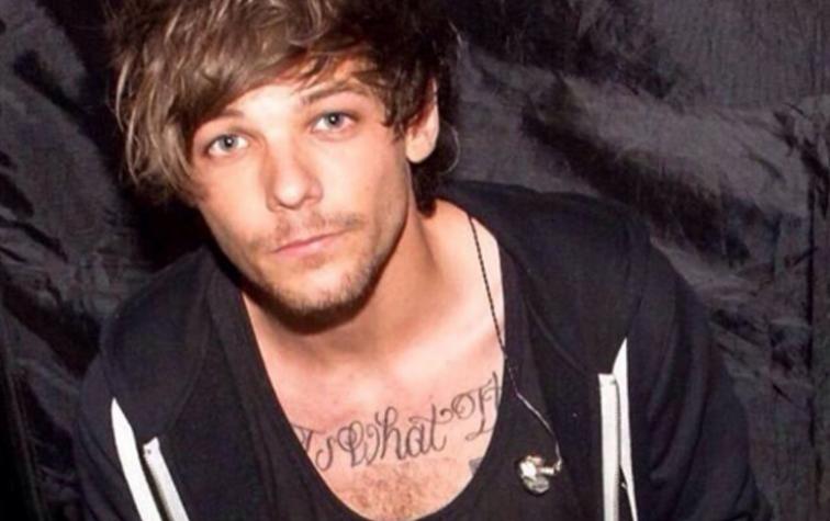 Louis Tomnlinson enternece Facebook besando a su hijo